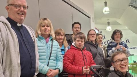 Parents and their disabled children turned out to lobby Telford & Wrekin Council. A group of men, women and young people are gathered together, with a counter visible behind them.