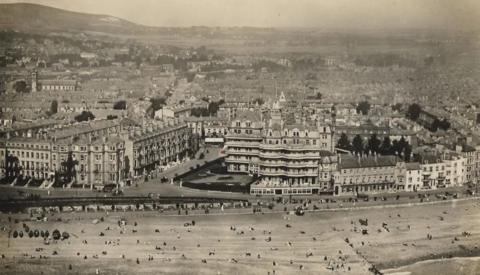 The Queens Hotel in Eastbourne during the 1900s. The black and white image shows the hotel, which is on the seafront.