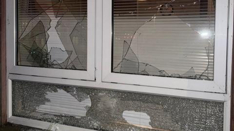 Three window panes with broken glass