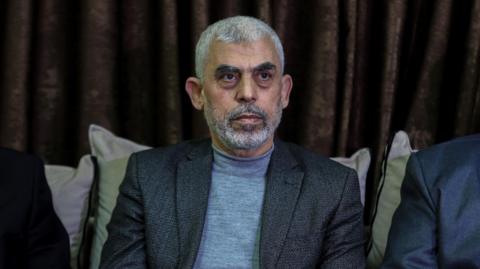 Yahya Sinwar pictured in a jacket sitting down