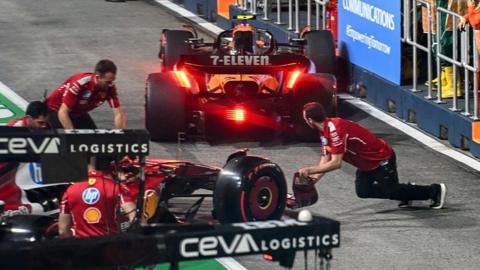 The aftermath of Ferrari's Charles Leclerc and McLaren's Lando Norris colliding in the pit lane