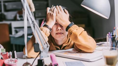 Student with head in hands while studying