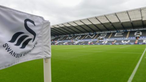 A general view of Swansea.com Stadium with a Swansea City branded corner flag in foreground