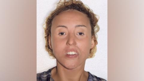 A computer generated image of a woman with a blank expression and curly blond hair