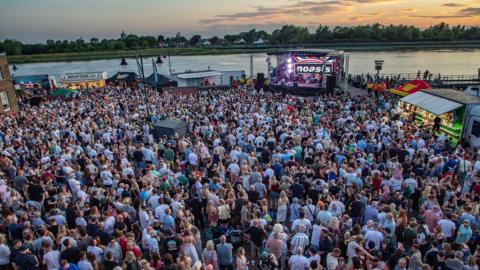 An aerial view of the Quayside in King's Lynn at sunset which filled with people watching an Oasis tribute band