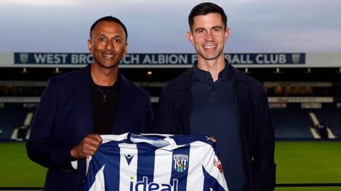 West Bromwich Albion owner Shilen Patel stands on the left next to new head coach Eric Ramsay with the two hold a club shirt between them