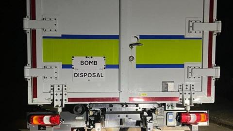 The back of a van which says "BOMB DISPOSAL" on it.