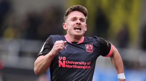 Sam Hoskins celebrates after scoring the winning goal against Burton Albion