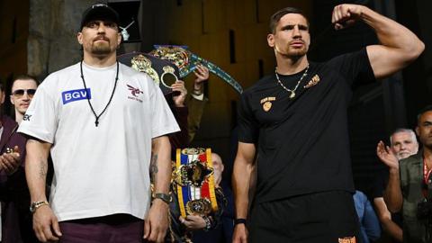 Oleksandr Usyk and Rico Verhoeven pose at the weigh-in