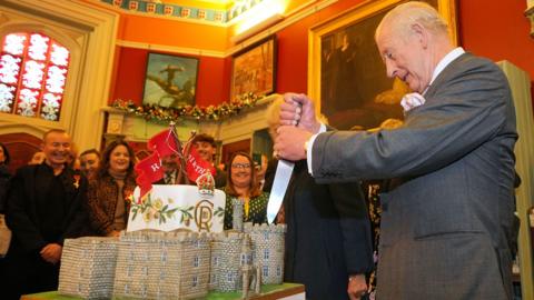 King Charles cuts a birthday cake at Cyfarthfa Castle on his 77th birthday