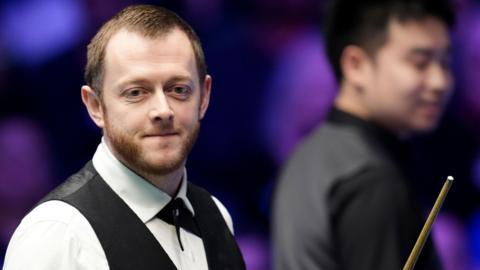 Mark Allen smiles during his Masters match against Si Jiahui