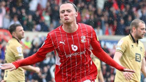 Harry McKirdy celebrates his goal for Swindon