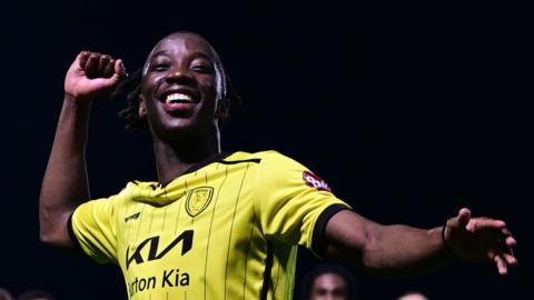 Burton Albion's Kegs Chauke celebrates the club staying up in League One