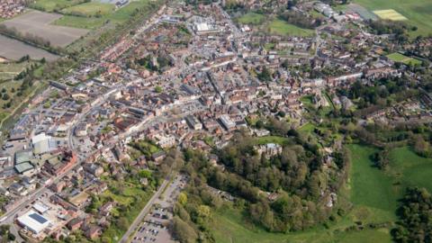 An aerial view of Devizes in Wiltshire, with houses and trees.
