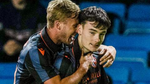 Dylan Levitt (second right) scored in extra-time for Dundee United