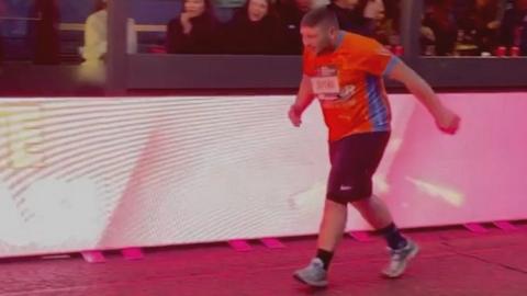 Tom Drunin running towards London Marathon finish line