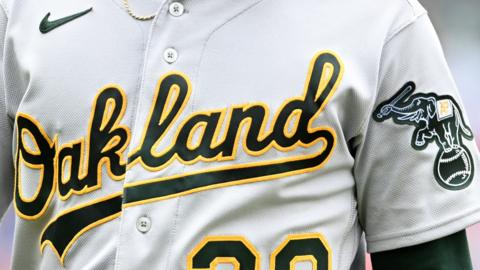 A close-up of the Oakland Athletics logo on a baseball jersey