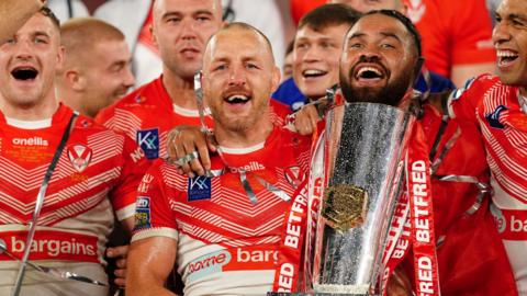 Captain James Roby holds the Super League trophy as Saints celebrate