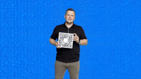 A man holds a QR code
