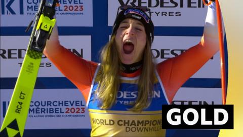 Jasmine Flury celebrates her victory lifting her skis into the air