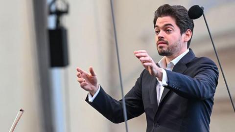 File photo showing Israeli conductor Lahav Shani wearing a dark-coloured blazer and a white shirt
