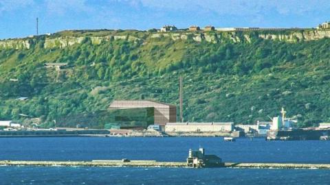 Computer-generated image of the power plant and chimney with Portland Harbour in the foreground and cliffs of Portland behind 