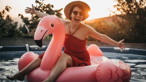 Woman on an inflatable flamingo