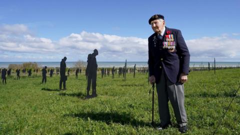 File photo dated 18/04/24 of D-Day veteran and Ambassador for the British Normandy Memorial Mervyn Kersh stands amongst the Standing with Giants silhouettes at the For Your Tomorrow installation at the British Normandy Memorial, in Ver-Sur-Mer, France. 