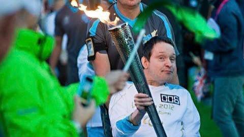 A younger Chris Channon carrying a torch