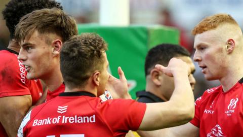 Nathan Doak, Michael Lowry and Ethan McIlroy celebrate Doak's try