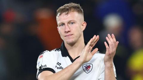 Ross McCrorie applauds fans at the end of Bristol City's match with Wrexham