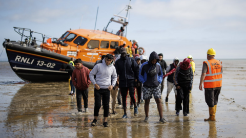 People believed to be asylum seekers arrive in the UK