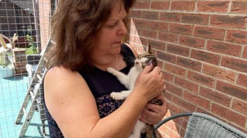 Gill Atkins with a cat at Last Resort Rescue in Spilsby