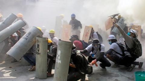 Protesters take cover in Yangon