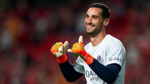 Sergio Rico smiling while warming up ahead of a Paris St-Germain match in October 2022.