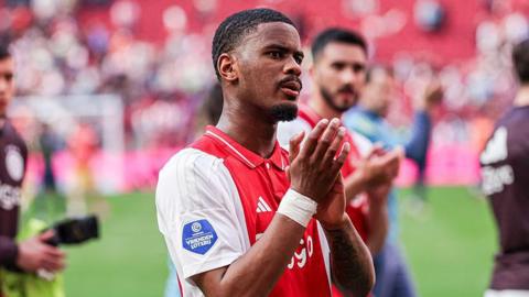 Jorrel Hato applauds the crowd after an Ajax match