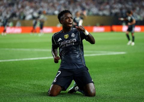 Vinicius Jr slides on his knees to celebrate scoring a goal