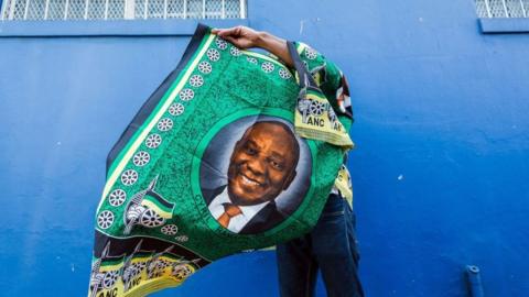 A street vendor sells goods depicting South African President Cyril Ramaphosa on 12 January 2019.