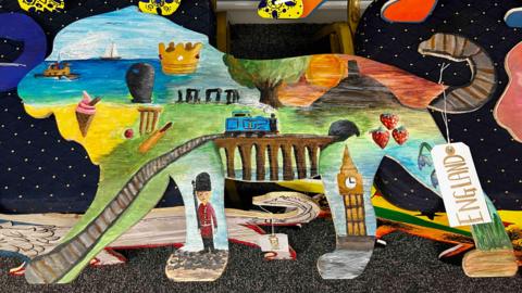 A wooden lion has been painted with traditional 'England' images including Big Ben, cricket and Stonehenge.