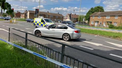 Closed road with a car in the middle 