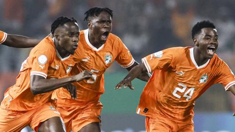 Ivory Coast midfielder Franck Kessie celebrates with forward Christian Kouame after scoring his team's first goal from the penalty spot during the Africa Cup of Nations (Afcon) 2023 round of 16 football match between Senegal and Ivory Coast at the Stade Charles Konan Banny in Yamoussoukro