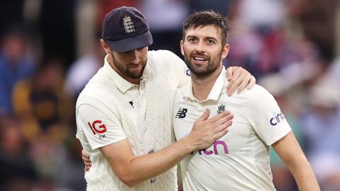 England bowlers Chris Woakes (left) and Mark Wood (right) celebrate