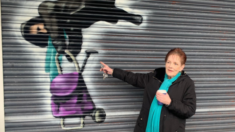 Anne Hughes with her mural