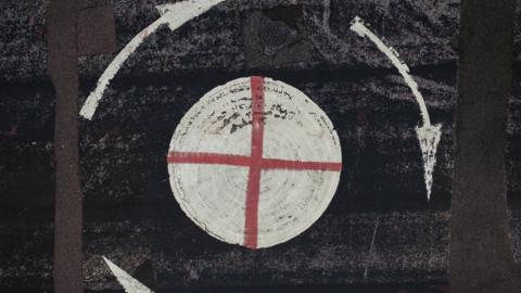 The cross of St George daubed on a mini-roundabout, pictured from above.
