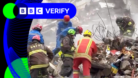Rescue workers clearing and moving rubble