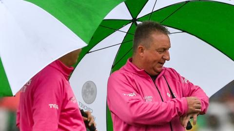Umbrellas were required for the umpires at Malahide on Wednesday