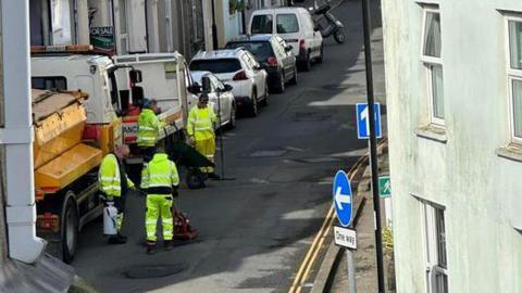 Workers filling in potholes