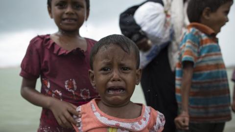 A Rohingya Muslim child cries during a rain storm after arriving by boat from Myanmar on September 08, 2017 in Dakhinpara Bangladesh
