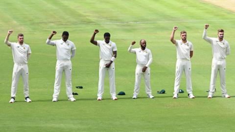 South Africa's cricketers raise their right fists in an anti-racism gesture before the first Test against Sri Lanka