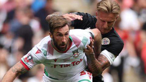 Ollie Palmer of Wrexham is tackled by Byron Webster